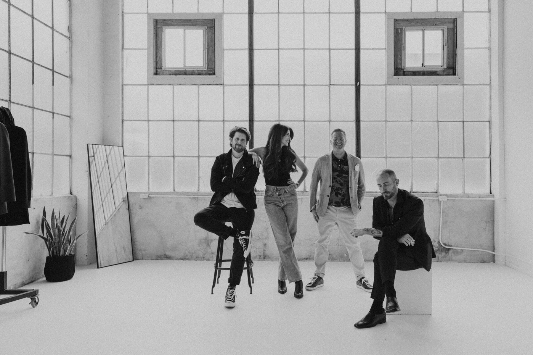 Stylist collective seated together in a bright studio